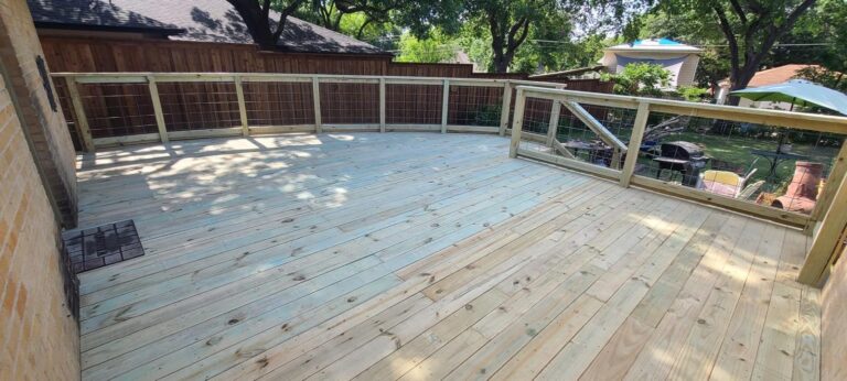 Pressure-treated wood deck with modern cable railing built in North Texas