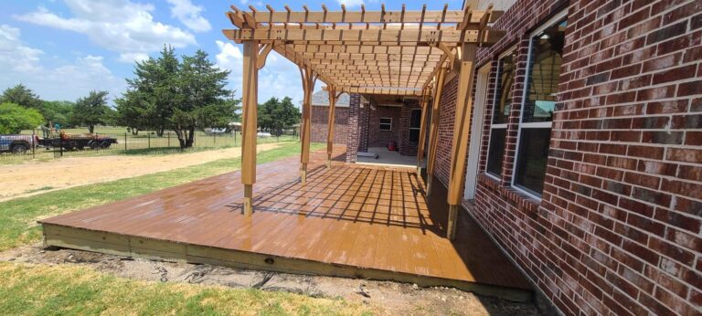 Stained wood deck and attached pergola on a Texas ranch property
