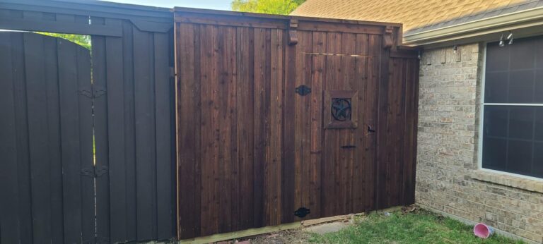 Dark-stained cedar double drive gate with Texas star and decorative corbels