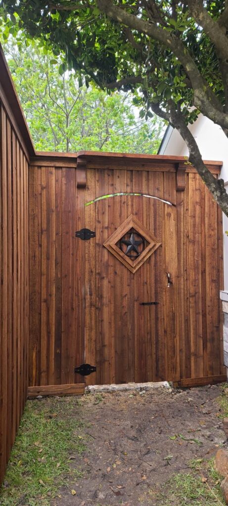 Close-up of an arched cedar gate with Texas star and diamond cutout detail