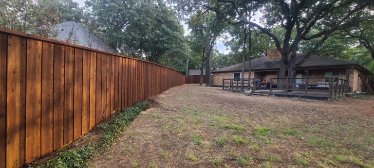 Stained cedar privacy fence enclosing a full backyard in North Texas