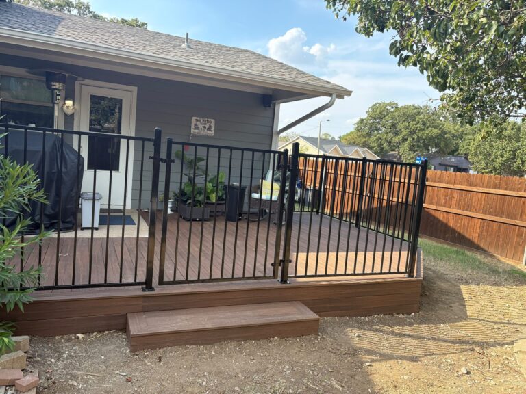 Composite deck railing gate opening onto a matching step