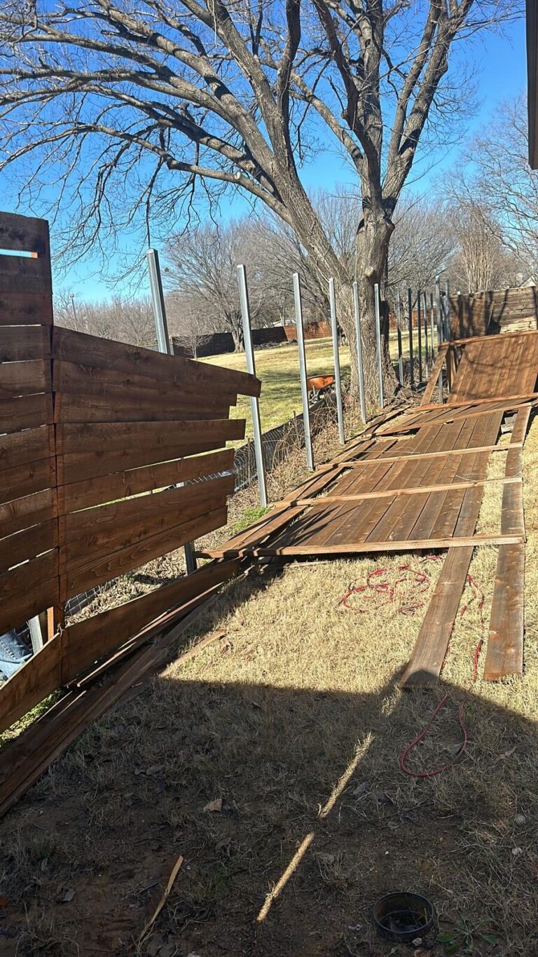 Old fence being removed next to a new horizontal fence