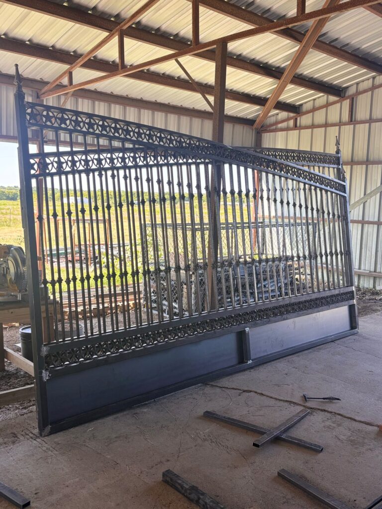 Ornamental wrought iron driveway gate under fabrication in the Grace Construction shop